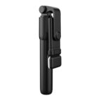 A black foldable selfie stick with a handle and a phone holder, compactly folded for easy portability. The stick has a sleek and modern design.