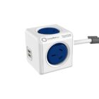 A white cube-shaped power strip with two blue electrical sockets on the top and side, and two USB ports on one side. The power strip is connected to a gray power cord.