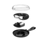 Exploded view of a compact charging station. From top to bottom: clear cover, coiled cable with USB connectors, black internal docking area, and a black circular base with a handle.