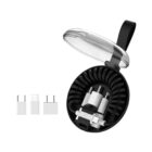A round black case with a transparent lid containing a coiled charging cable and various adapters. Three additional adapters are placed beside the case. A black strap is attached to the lid for carrying.