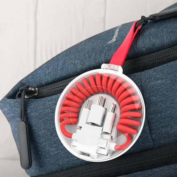 A blue backpack with a round travel cable organizer attached to it. The organizer has a clear case, and inside, a red coiled cable is visible with several white connectors.