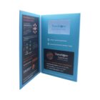 Open brochure with a blue theme featuring information about Transitions Signature adaptive lenses. One side displays text and graphics, while the other side contains product details and benefits, like enhanced color and quicker adaptation.