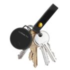 A set of four metal keys is attached to a black leather keychain. The keychain has a small round electronic tracker labeled SwiftFinder DUO.