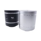 Two cylindrical Bluetooth speakers are shown. One is black with control buttons and a micro USB port on the back, while the other is silver with a smooth surface. Both have metallic bands near the top and base.