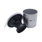 Two portable bluetooth speakers are shown. One is silver and cylindrical with a black top. The second is black with a suction base, positioned side by side, showcasing their ports and buttons.