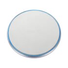 A round, flat white wireless charging pad with a metallic rim and a blue LED indicator. The surface appears smooth, designed for charging smartphones and compatible devices.