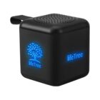 Black cube-shaped portable speaker with blue lifeTree logo and tree graphic illuminated.