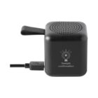 Small black cube-shaped speaker with USB cable and Sample confirmation icon on front.
