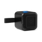 Small black cube-shaped electronic device with power button and short strap attached.