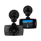 Two car dash cameras are shown. The front camera has a lens with multiple infrared LEDs, while the back view shows an LCD screen displaying a highway scene. Both cameras have suction mounts attached.