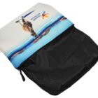 A travel pouch with a vibrant print of a kangaroo against a blue sky and landscape, featuring Queensland Australia and a colorful logo, on a black fabric base with a zipper.