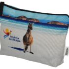 A pouch with an image of a kangaroo on a beach and the Tourism Australia logo. The background shows blue ocean waves and a sandy shoreline, with a zipper closure at the top.