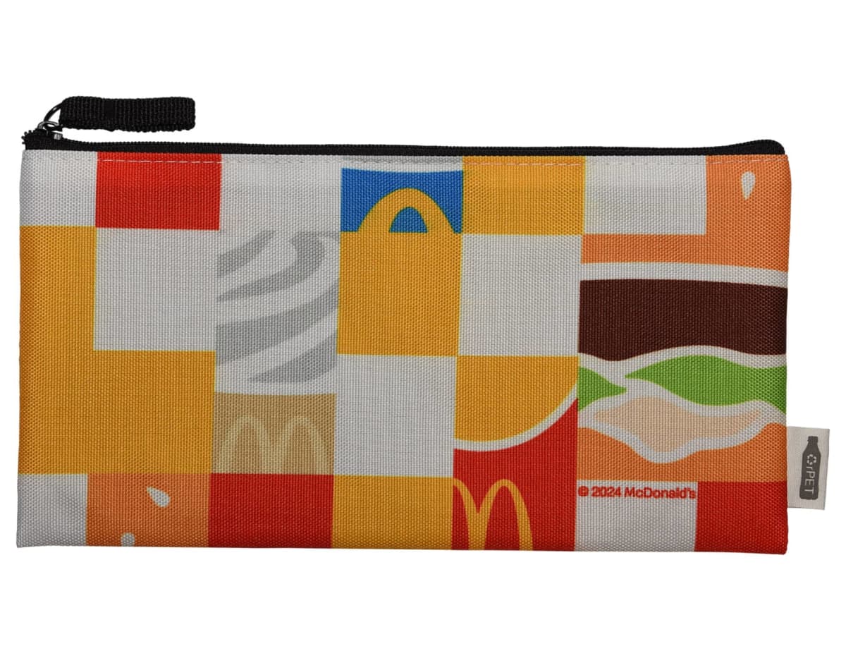 A zippered pouch with a colorful patchwork design featuring elements like the McDonalds logo, hamburger, and french fries. The mix of squares includes red, yellow, brown, and orange hues.