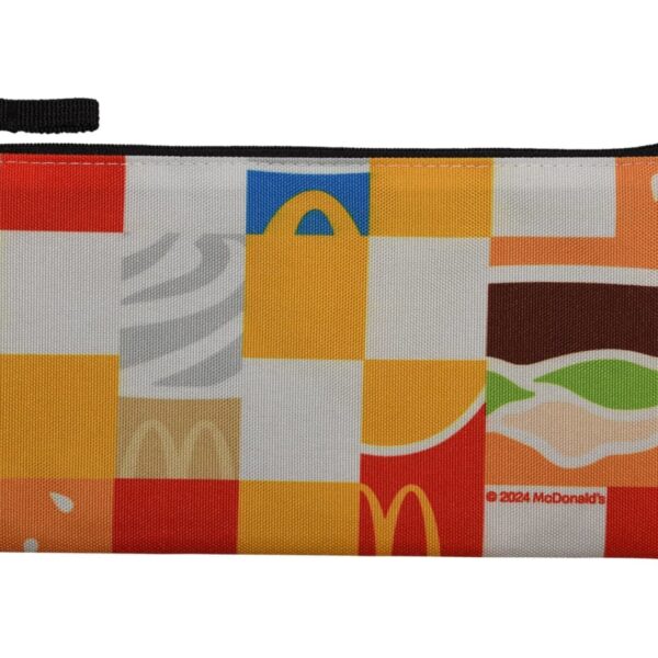 A colorful fabric pouch featuring a patchwork design with McDonalds themed elements such as the iconic golden arches, burger graphics, and abstract shapes in red, yellow, brown, and white, with a black zipper on top.
