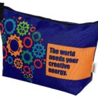 A blue zippered pouch with colorful gear designs and the words The world needs your creative energy on an orange rectangle.