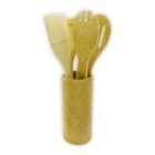 Bamboo utensil holder with four utensils: a flat spatula, a slotted spoon, a pasta server, and a standard spoon. The tools are made of light bamboo and are placed upright in the cylindrical holder.