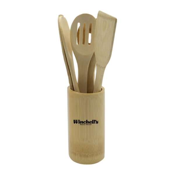 A bamboo holder containing four wooden kitchen utensils: a spoon, slotted spoon, spatula, and angled spatula. The holder has Winchells printed on it.
