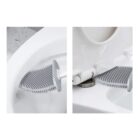 A toilet showing a dual-image view of a silicone cleaning brush. One side displays the brush on the toilet rim, and the other shows it cleaning under the seat hinge. The brush has soft bristles for easy cleaning.