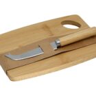 A wooden cutting board with a cheese knife secured by a brown paper band.