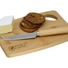 Cheese, crackers, and a knife on a wooden board labeled Wyllie St Coffee.