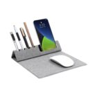 A gray desk organizer featuring slots with pens and a stylus, a phone stand holding a smartphone displaying the time as 3:20, and a wireless mouse resting in front. The organizer is made of fabric and has a sleek, minimalist design.