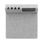 A gray fabric-covered electronic device with a slanted screen and multiple circular buttons on top. The design is minimalist and modern, resembling a smart home assistant or speaker.