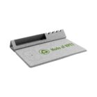 A grey desk organizer made of RPET fabric includes a slanted phone holder, a section for stationery, and a wireless charging pad. The phrase Made of RPET is printed in green alongside a recycling symbol on the surface.