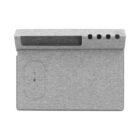 A gray, fabric-covered modern electronic charging station with a wireless charging pad on the left side and four USB ports on the top edge, designed for organizing and charging multiple devices.