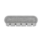 A gray fabric-covered cable organizer with five slots for holding cords and cables. The design is simple and modern, suitable for decluttering workspaces.