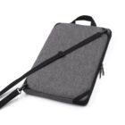 Grey laptop sleeve with a black adjustable shoulder strap and handle, featuring a zippered closure. The sleeve is designed for portability and protection.