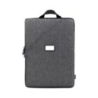 A gray rectangular backpack with a minimalist design featuring a diagonal zipper and a small rectangular patch in the center. It has a top handle for easy carrying.