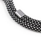 Close-up of a black and white braided rope with a silver metal clasp in the center. The rope features a checkered pattern with alternating colors, showcasing its texture and design.