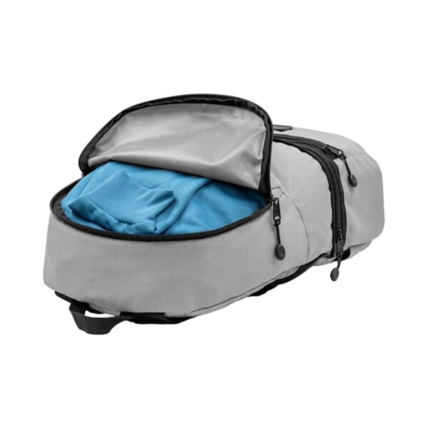 A gray duffel bag partly unzipped to reveal a blue shirt inside. The bag has multiple compartments and black zippers.