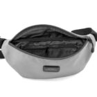 A gray waist bag with a partially open zipper shows a black interior and inner zip pocket. The bag has a black adjustable strap and a black rectangular label on the front.