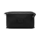 A sleek, rectangular black shoulder bag with a minimalist design. The bag features a zipper closure at the top and an adjustable shoulder strap. A small rectangular patch is visible on the front.
