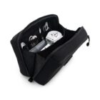 A black travel pouch open to reveal electronic accessories, including a universal power adapter, a few cables, and a compact charger. The pouch has a sleek design with organized compartments for easy storage.