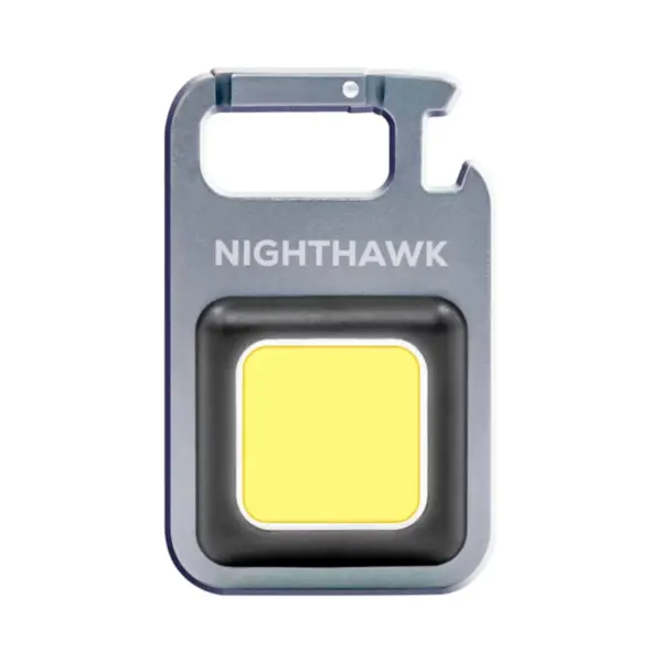 Meet the Nighthawk Compact LED Tool—a small, square-shaped carabiner light with NIGHTHAWK printed on its metallic finish. It features a large yellow light panel at the center, ideal for illuminating your adventures.