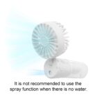 A small, white handheld fan with a visible spray function emits a mist. Text below reads, It is not recommended to use the spray function when there is no water.
