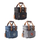 Three insulated lunch bags with brown handles. The bags come in black, blue, and gray, each with a front pocket, zippered main compartment, and unique logo on the front. Theyre designed for easy carrying and storage.