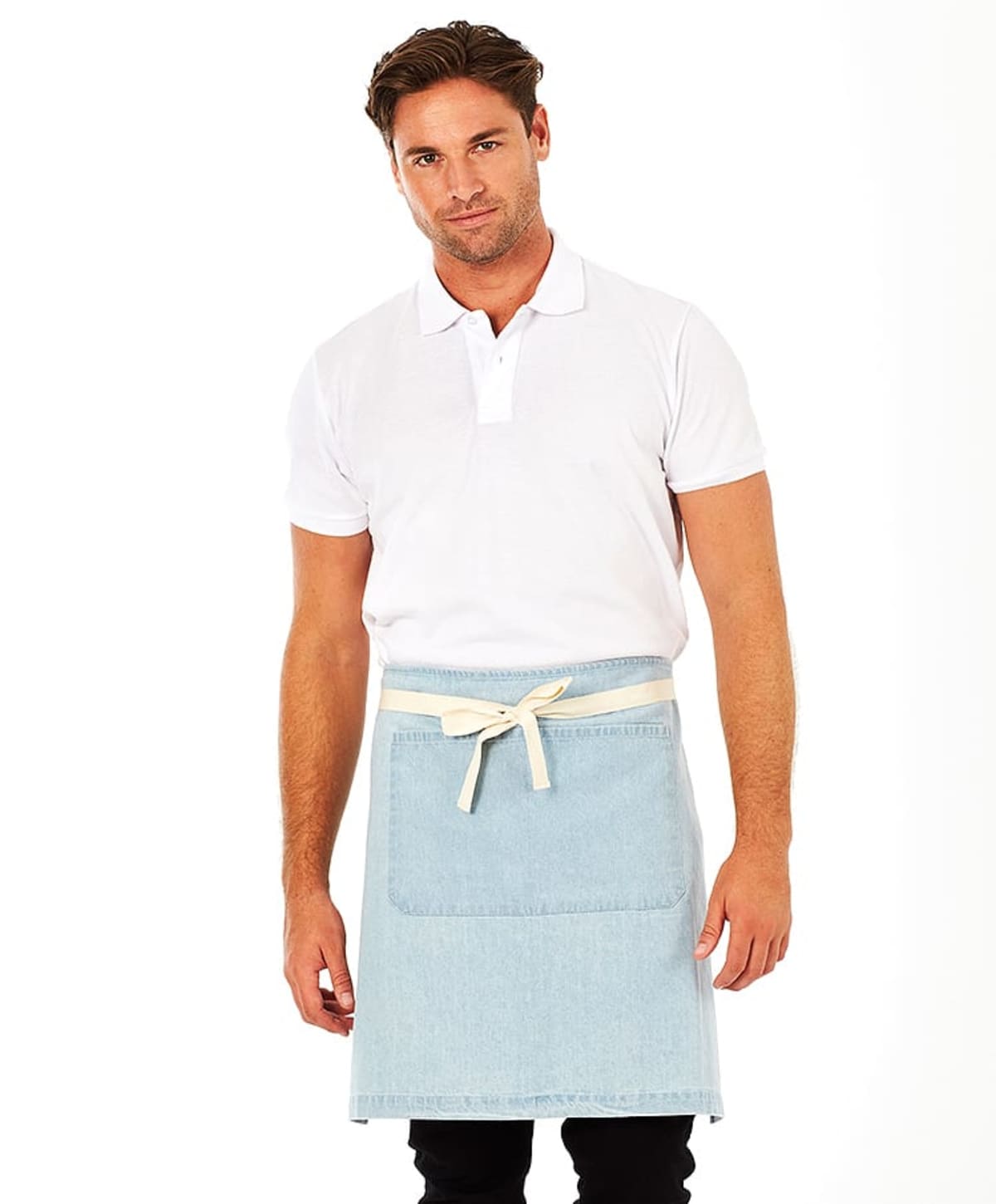 A person wearing a white polo shirt and a light blue apron stands against a plain white background. The apron has a front pocket and is tied with a beige strap. The individual has short brown hair and a slight smile.