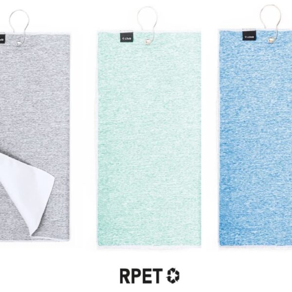 Three towels are displayed side by side. The towels are in shades of gray, mint green, and blue. Each towel has a loop at the top and a small black tag. The towel on the left is partially folded to show the white underside.