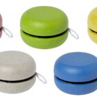 Five yo-yos in red, green, yellow, gray, and blue are arranged in a row. Each yo-yo has a white string attached.