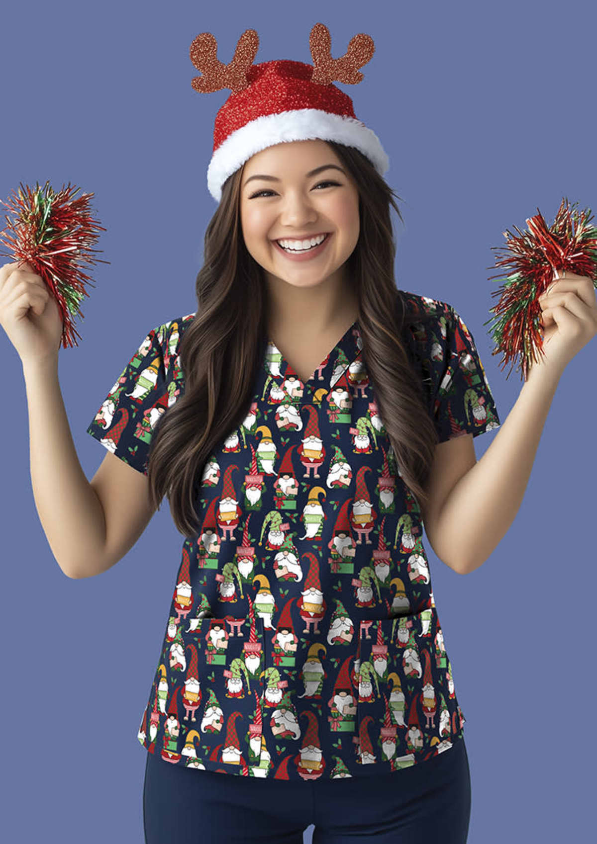 Smiling person wearing a festive reindeer antler hat and a scrub top with gnome patterns. They hold red tinsel pom-poms in both hands. The background is a solid light blue.