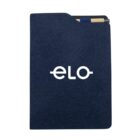 A dark blue notebook with a white eLo logo centered on the cover. A black and tan pen is tucked into the top, partially visible. The notebook has a pocket-style design at the top edge.