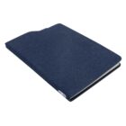 A closed, dark blue fabric-covered notebook with slightly rounded edges, lying on a white surface. The cover has a subtle texture, and a small part of the notebooks white pages is visible along the edge.