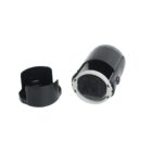 A black self-inking stamp with a detachable cap is shown. The stamp displays a circular design with numbers and a small tree emblem in the center. The cap is placed next to the stamp, open side up.
