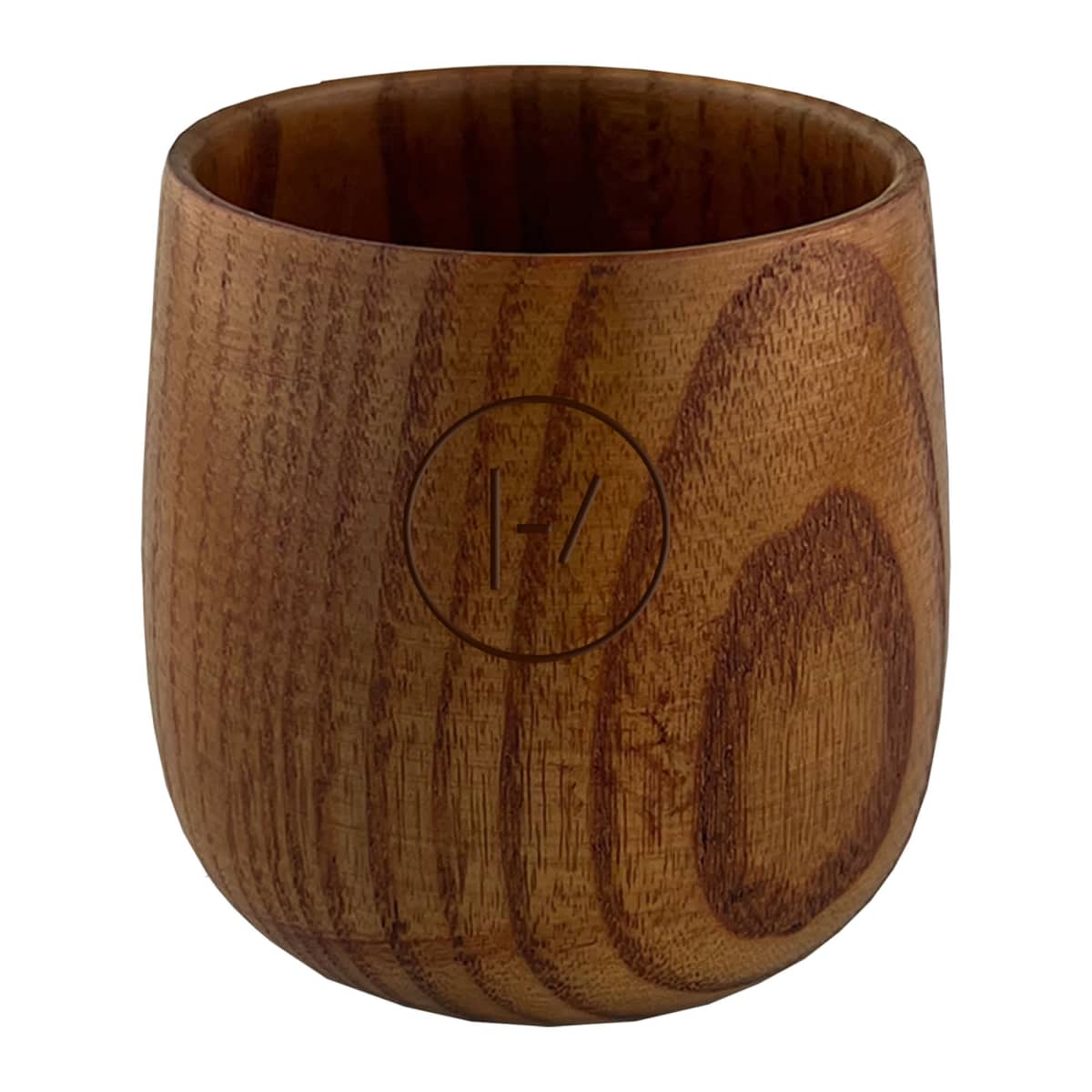 A round wooden cup with smooth grain patterns and a carved logo on the front featuring a circle enclosing 1/7. The cup has a natural finish, highlighting its rustic appearance.