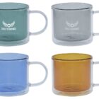 Four glass mugs in green, gray, blue, and amber, each with the Shutterwings logo.