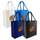 Four tote bags in white, blue, navy, and black, each with a 50th Anniversary logo featuring crossed baseball bats and a red baseball.