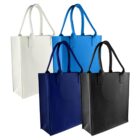 Four reusable tote bags in white, light blue, dark blue, and black. Each bag features two handles and is standing upright on a white background.